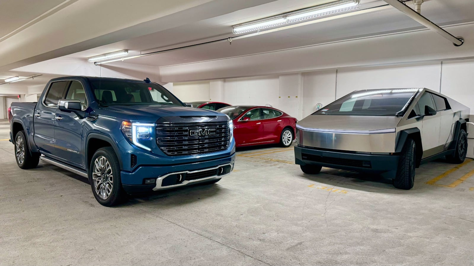 2024 GMC Sierra 1500 Denali Ultimate next to Tesla Cybertruck