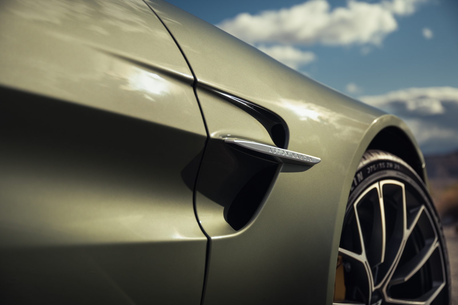The side fender vent of a pale green 2026 Aston Martin Vantage roadster