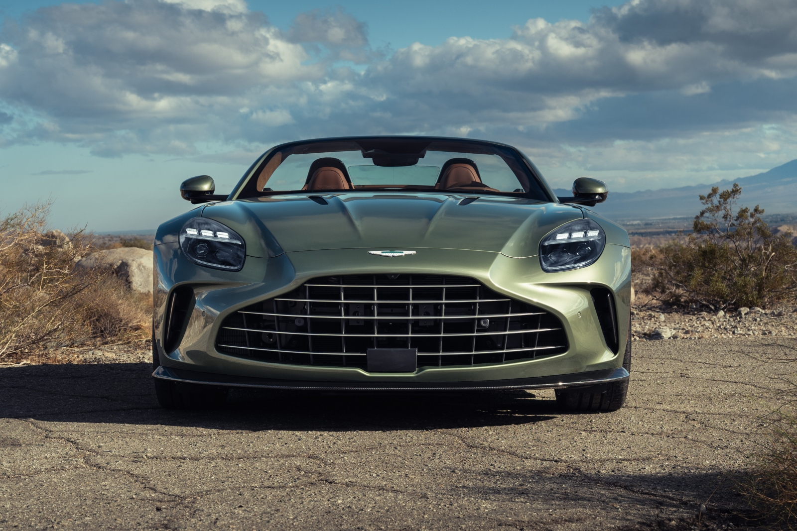 2026 Aston Martin Vantage Roadster exterior view of the front, with light green metallic paint