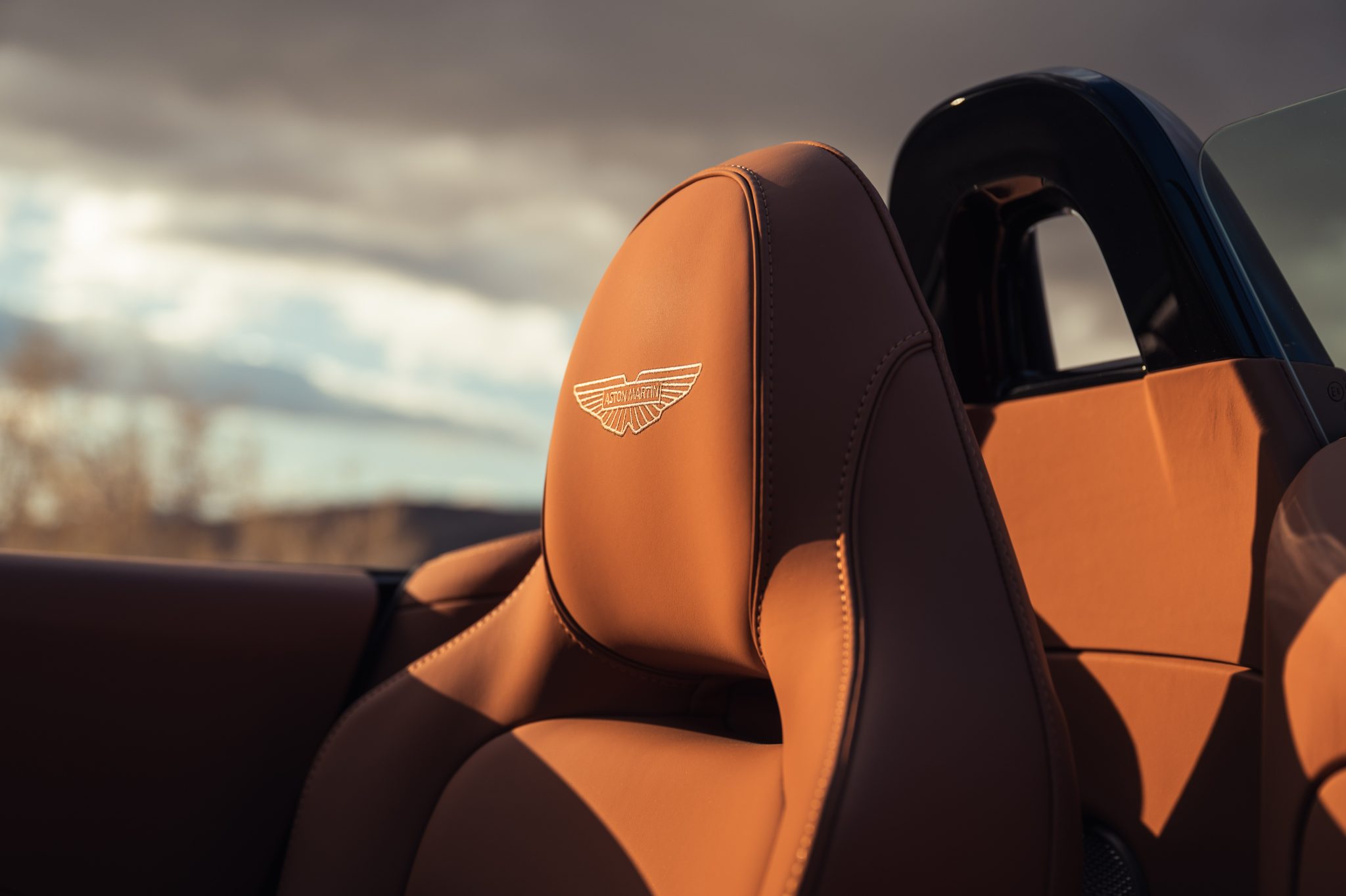 2026 Aston Martin Vantage Roadster tan leather seatback with embroidered logo